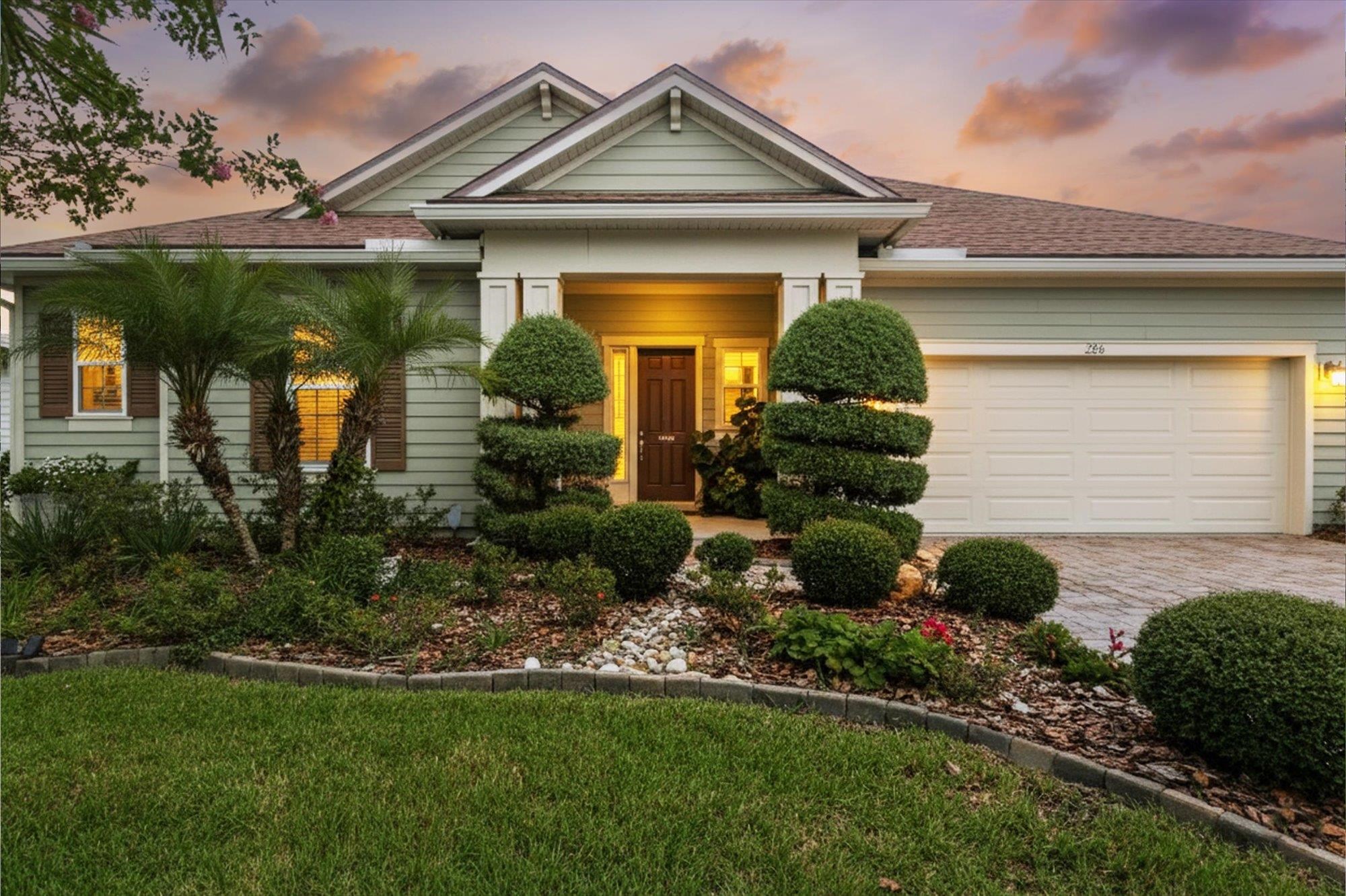 a front view of a house with garden