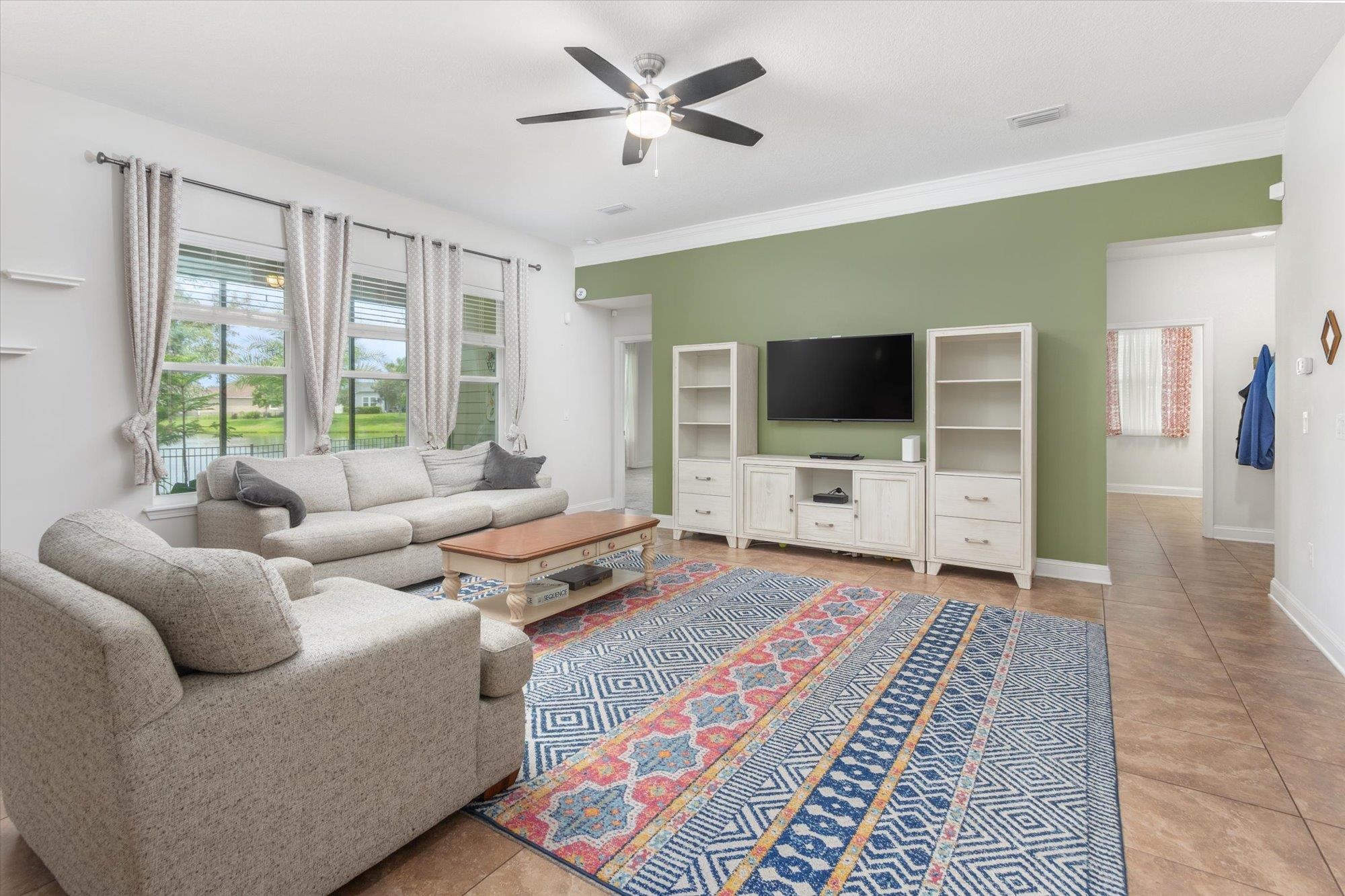 256 Vivian James Drive St. Augustine, FL 32092 - Photo 14 of 57 a living room with furniture and a flat screen tv
