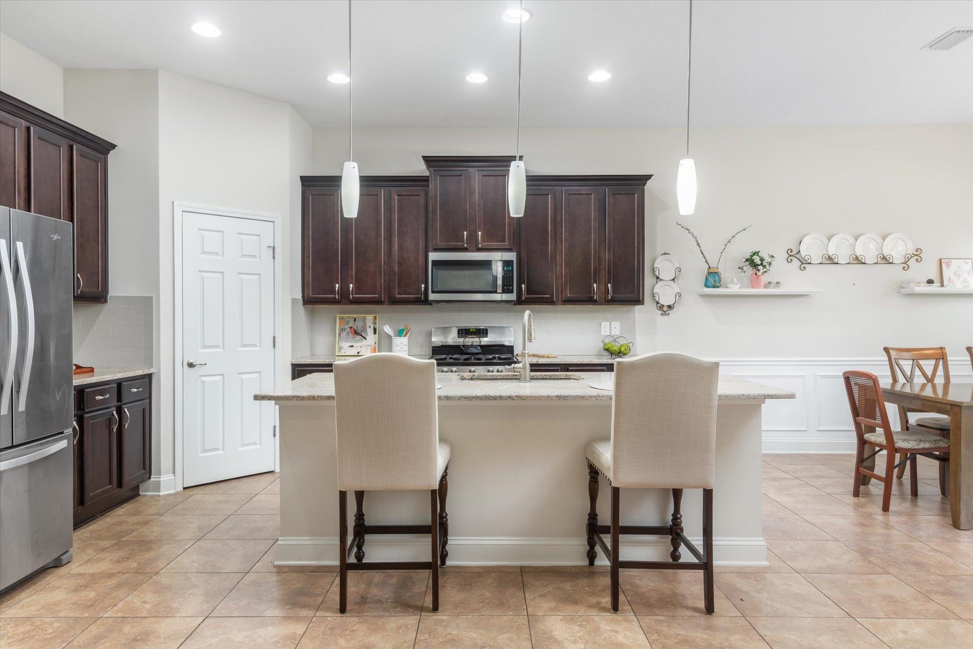 256 Vivian James Drive St. Augustine, FL 32092 - Photo 18 of 57 a kitchen with stainless steel appliances granite countertop a stove a sink a refrigerator and a microwave