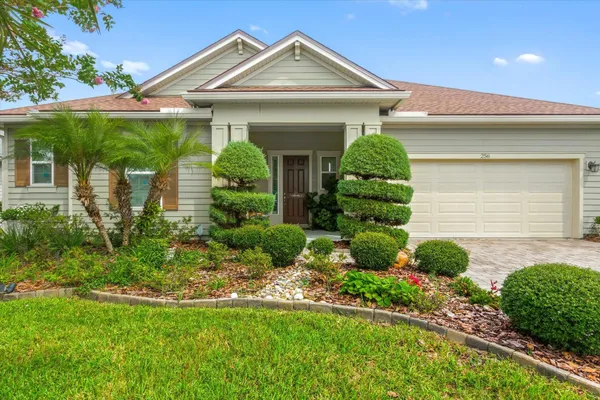 a front view of a house with garden