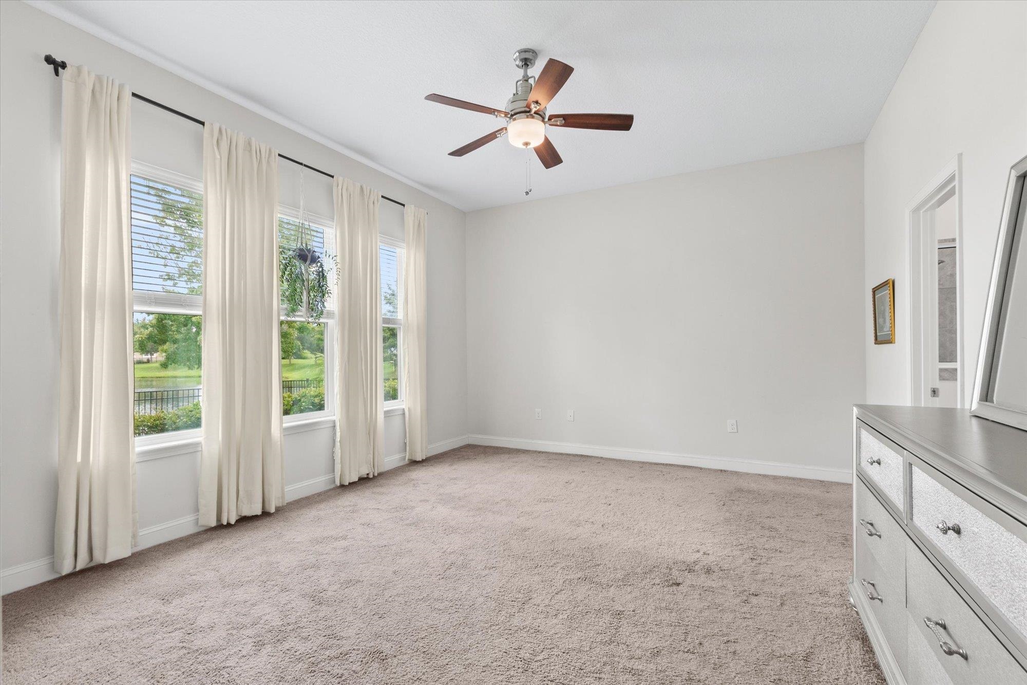 256 Vivian James Drive St. Augustine, FL 32092 - Photo 24 of 57 wooden floor in an empty room with a window