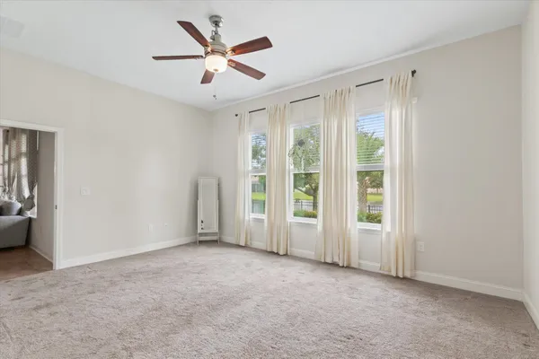 a spacious bathroom with a double vanity sink a mirror a bathtub and window