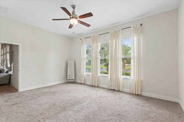 a spacious bathroom with a double vanity sink a mirror a bathtub and window