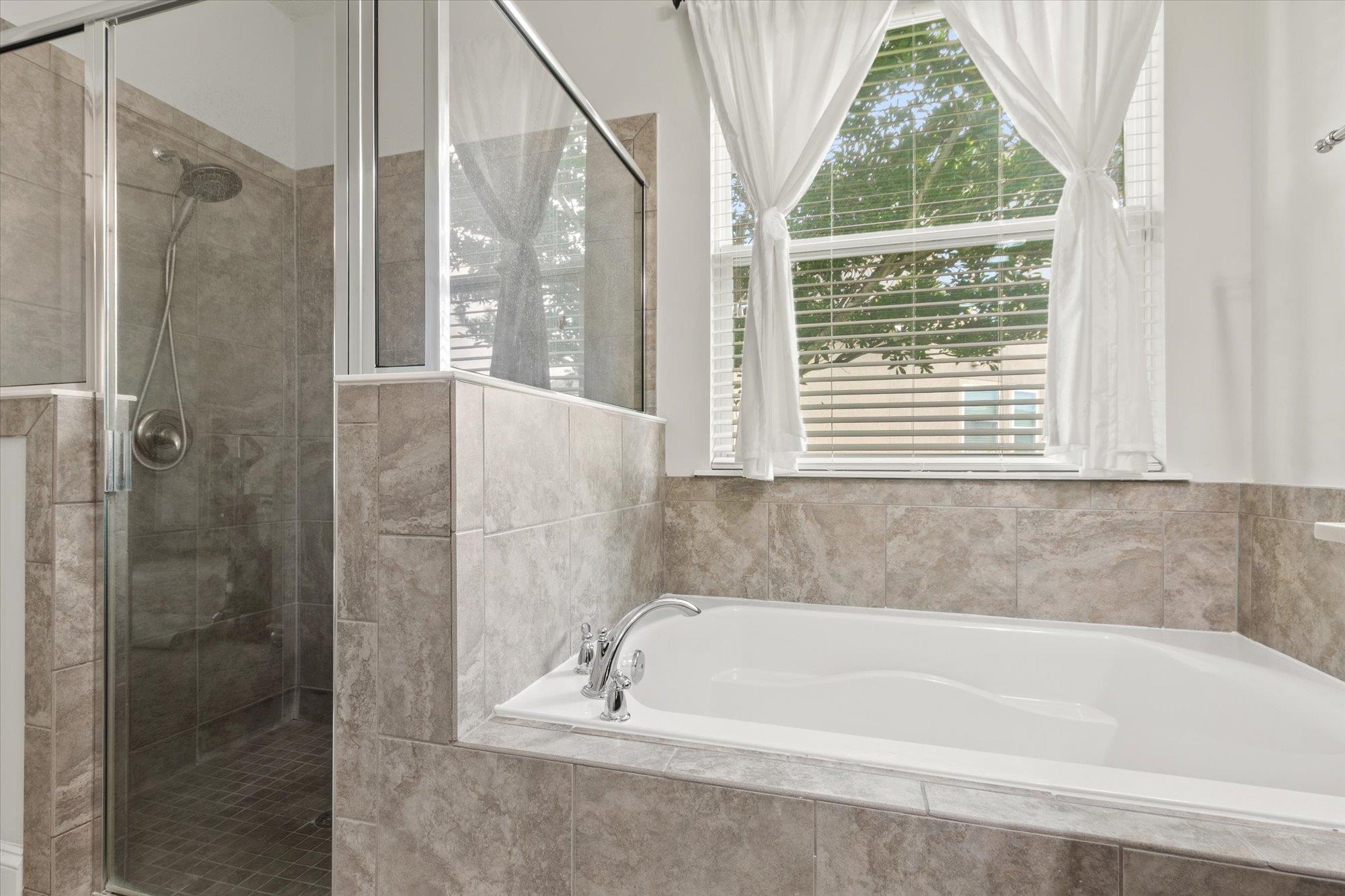 256 Vivian James Drive St. Augustine, FL 32092 - Photo 30 of 57 a bathroom with a bathtub and a shower