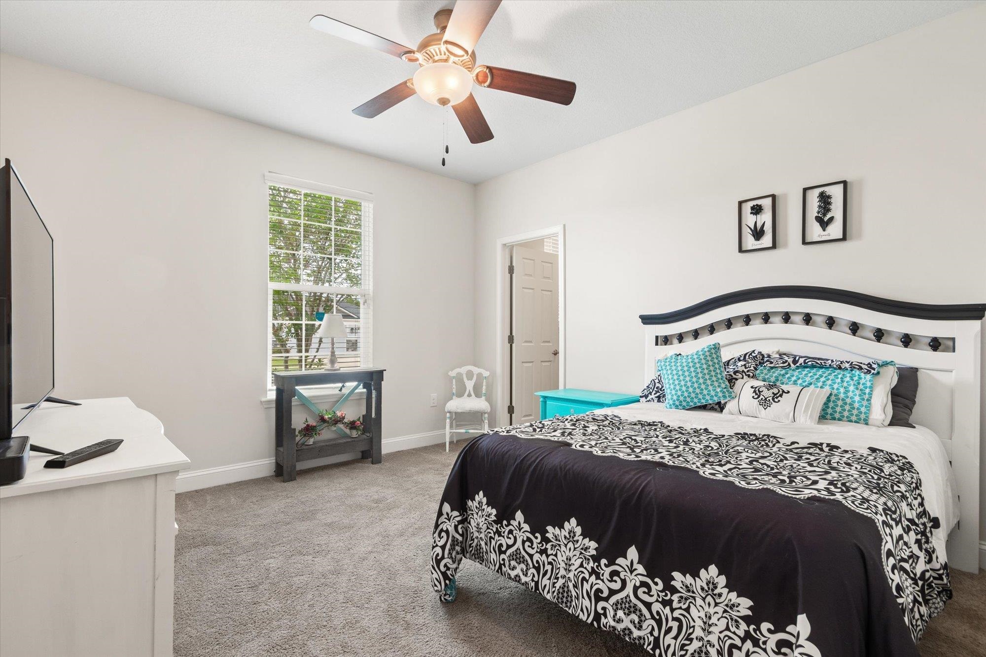 256 Vivian James Drive St. Augustine, FL 32092 - Photo 32 of 57 a bedroom with a bed and a chandelier