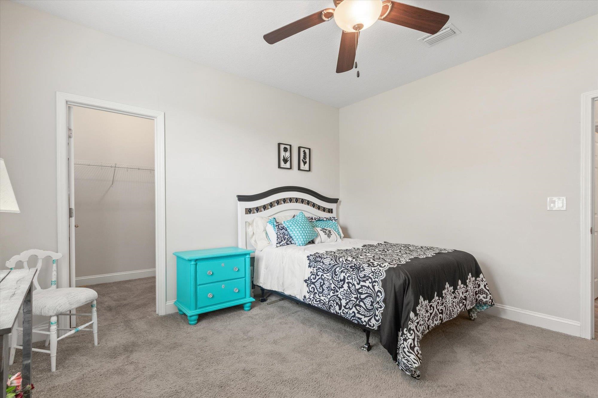 256 Vivian James Drive St. Augustine, FL 32092 - Photo 33 of 57 a bedroom with a bed and a chair