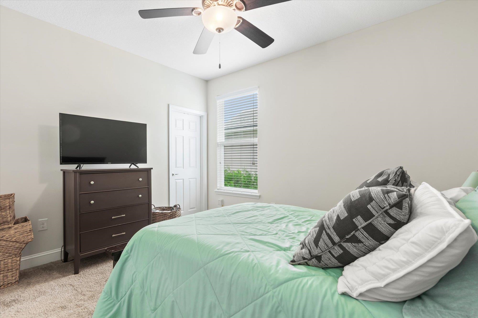 256 Vivian James Drive St. Augustine, FL 32092 - Photo 38 of 57 a bedroom with a bed and a flat screen tv