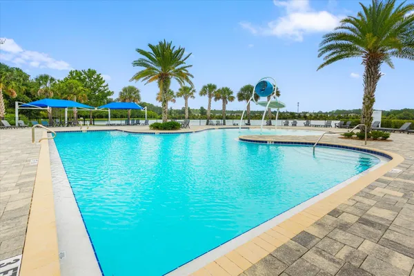 a view of a patio with a table and chairs under an umbrella