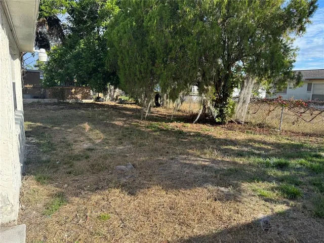 a view of a yard with a tree