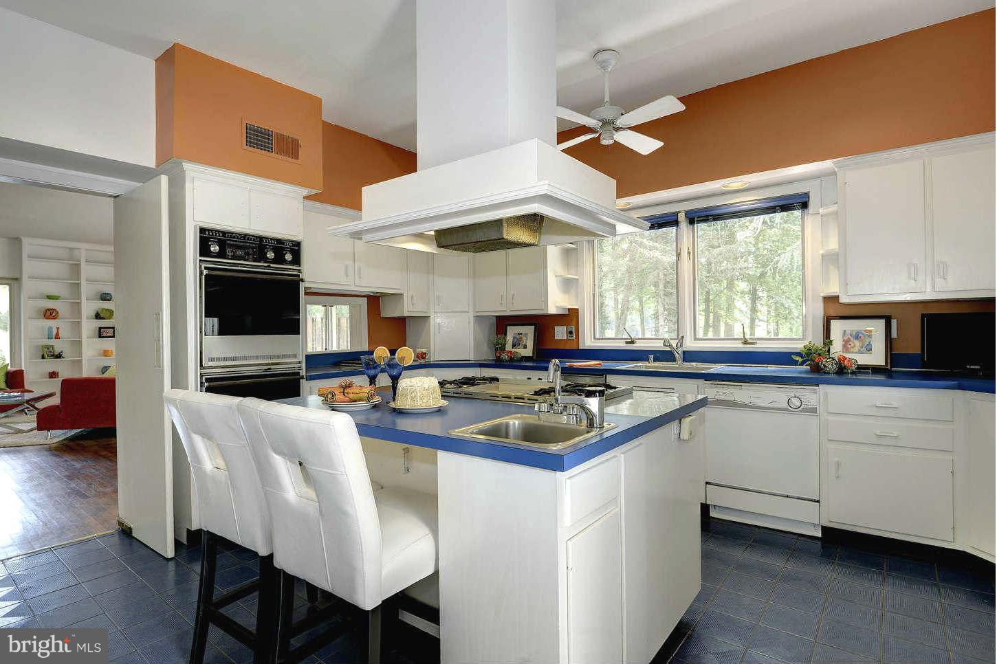 7324 Arrowood Road Bethesda, MD 20817 - Photo 11 of 30 a kitchen with stainless steel appliances granite countertop a sink dishwasher a stove and a refrigerator with wooden floor