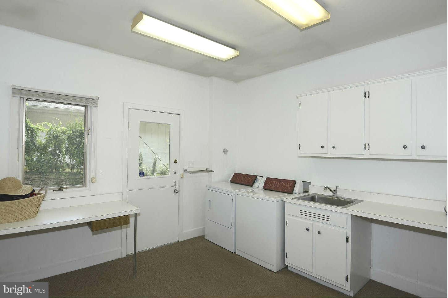 7324 Arrowood Road Bethesda, MD 20817 - Photo 15 of 30 a kitchen with white cabinets and sink