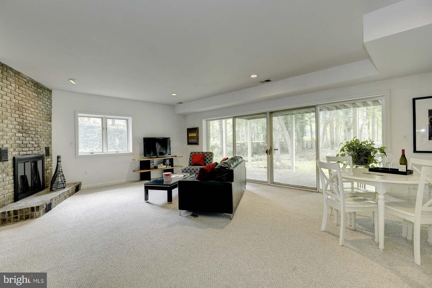 7324 Arrowood Road Bethesda, MD 20817 - Photo 19 of 30 a living room with furniture and a flat screen tv