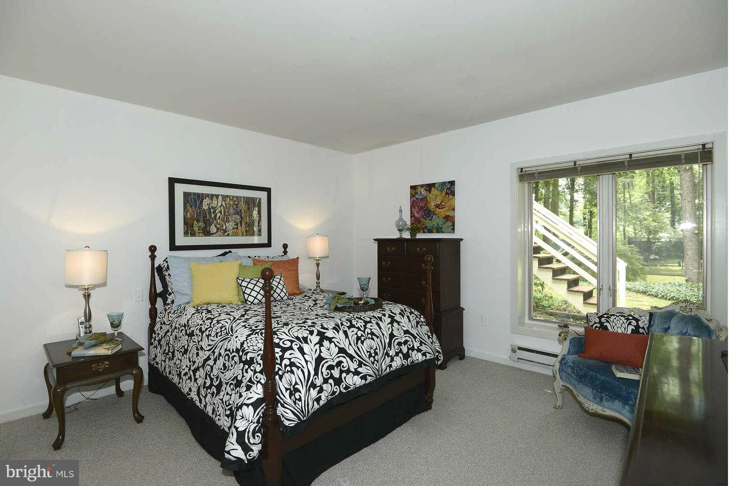 7324 Arrowood Road Bethesda, MD 20817 - Photo 20 of 30 a bedroom with a bed and a couch in it
