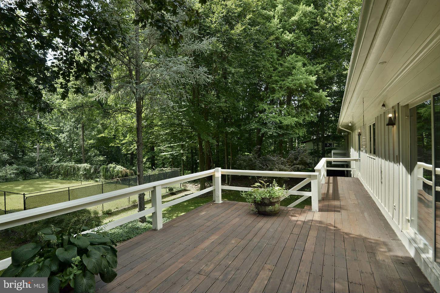 7324 Arrowood Road Bethesda, MD 20817 - Photo 24 of 30 a view of a balcony with wooden floor and bench