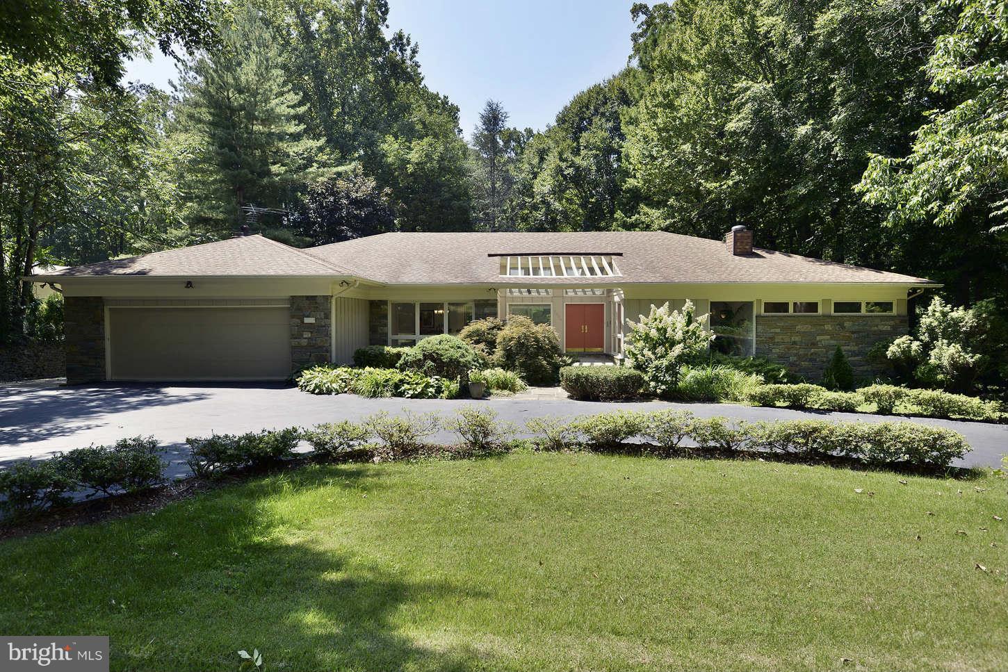 7324 Arrowood Road Bethesda, MD 20817 - Photo 27 of 30 a front view of a house with a garden