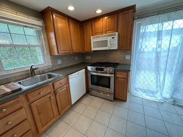 a kitchen with a stove sink and cabinets