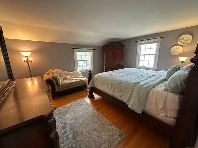 a bedroom with a bed and window