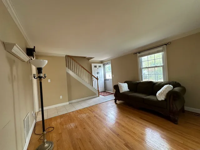a living room with couches and a coffee table with wooden floor
