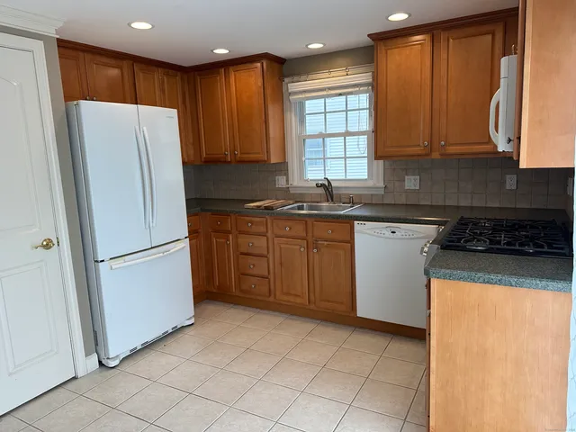a kitchen with stainless steel appliances granite countertop a refrigerator sink and cabinets