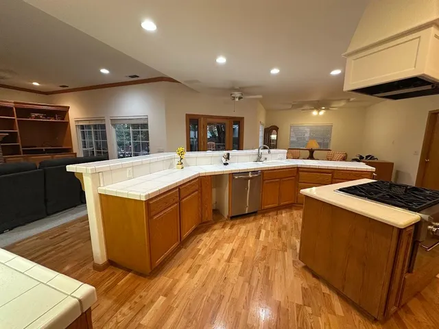 a kitchen with a sink a stove cabinets and a window