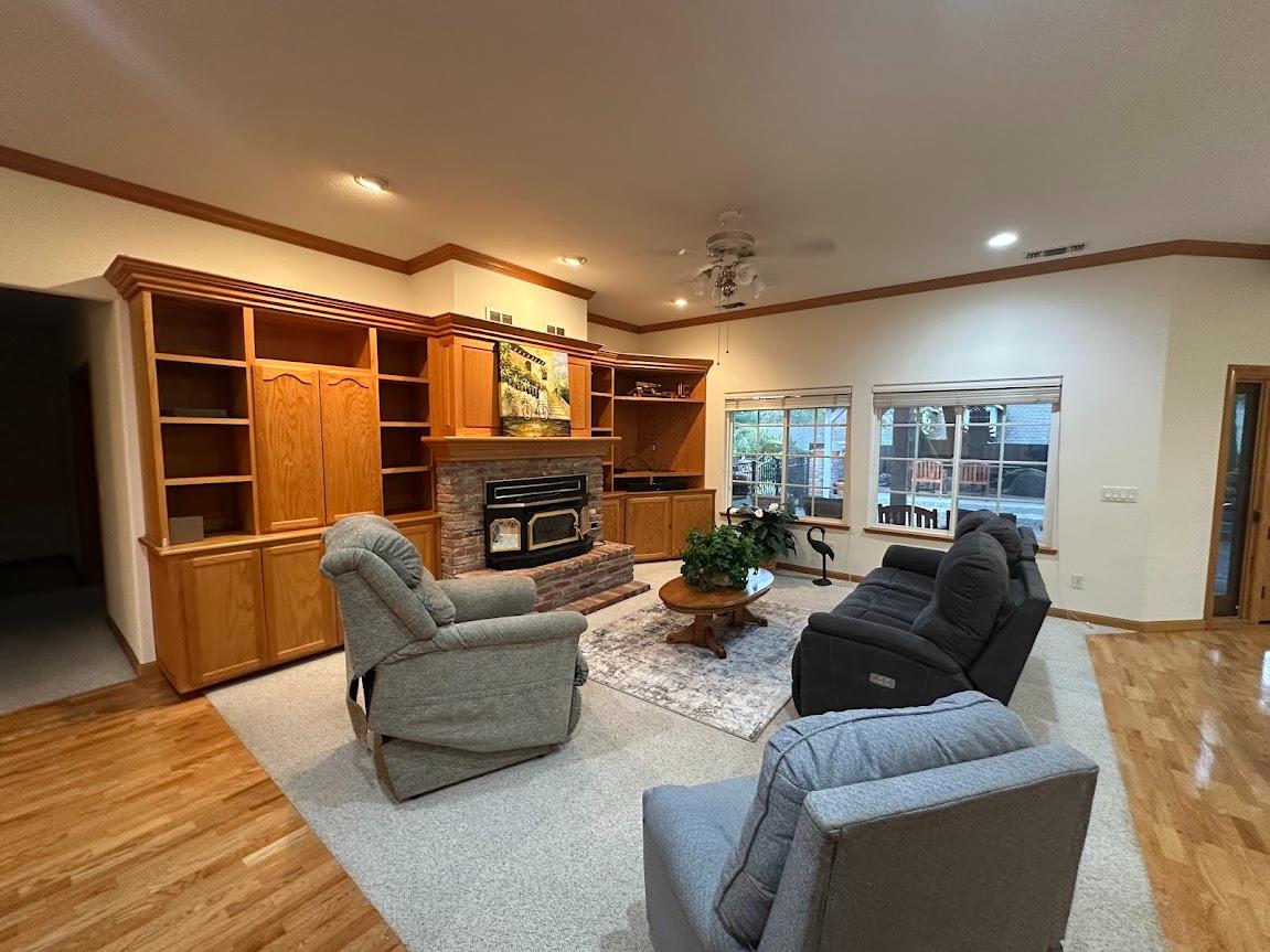 9130 Quail Lake Court Loomis, CA 95650 - Photo 15 of 31 a living room with furniture a fireplace and a flat screen tv
