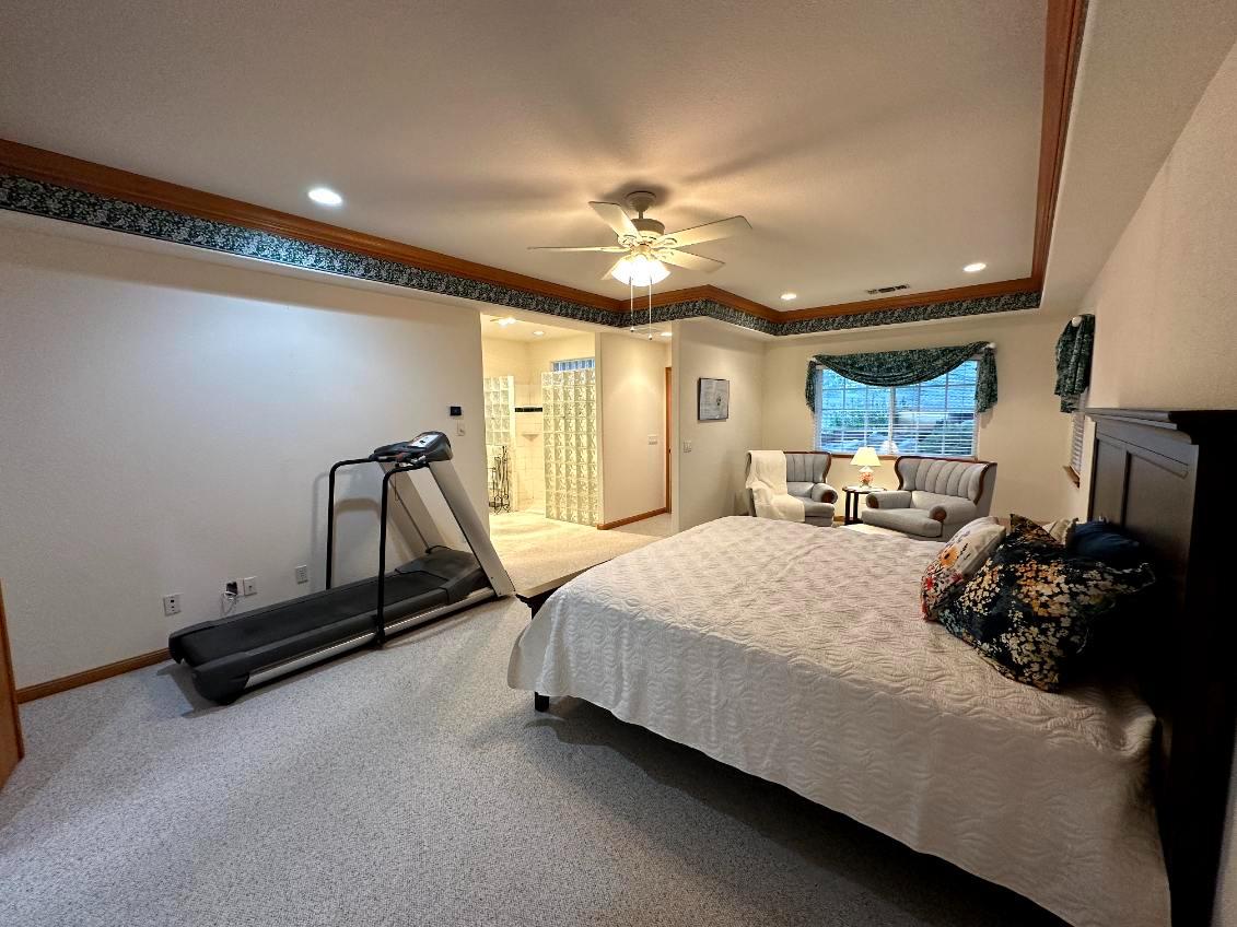9130 Quail Lake Court Loomis, CA 95650 - Photo 17 of 31 a bedroom with a bed and a chandelier