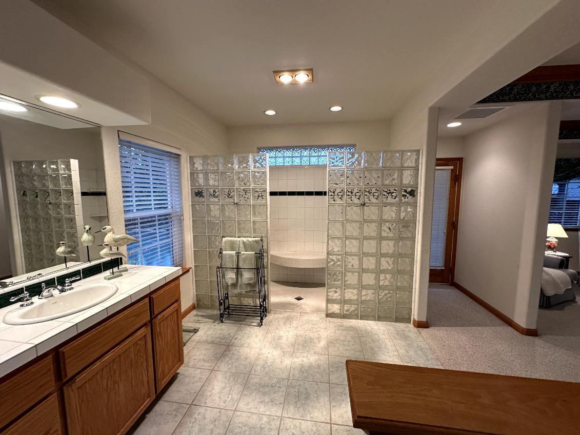 9130 Quail Lake Court Loomis, CA 95650 - Photo 19 of 31 a bathroom with a sink a toilet a mirror and shower