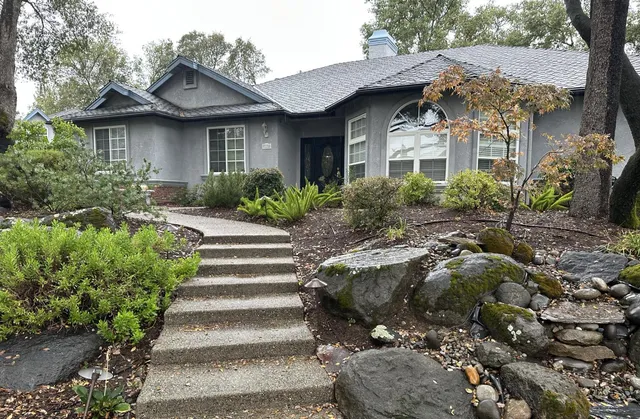 a front view of a house with a garden