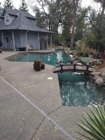 a view of a patio with a table and chairs under an umbrella