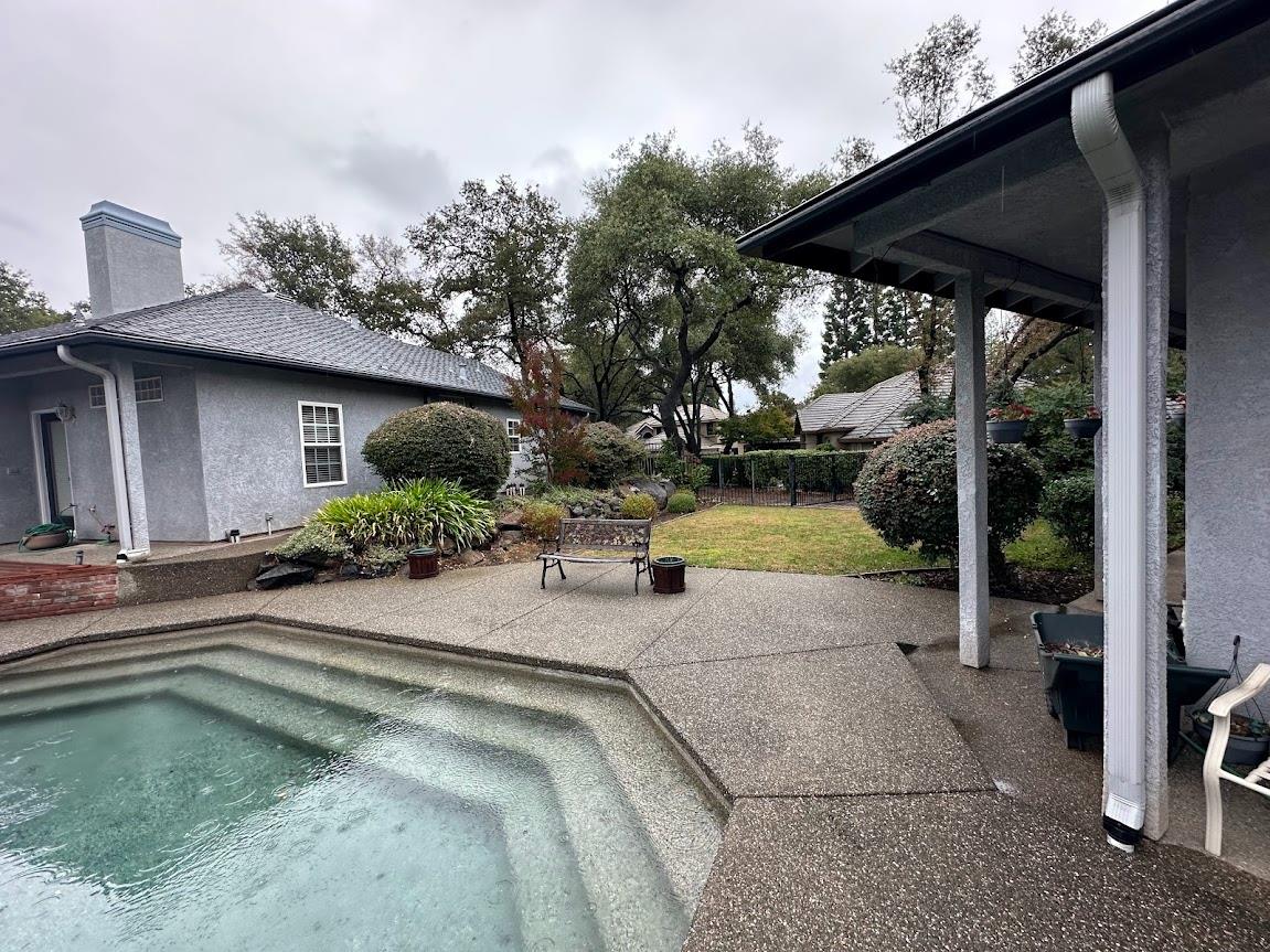 9130 Quail Lake Court Loomis, CA 95650 - Photo 27 of 31 a view of a patio with a table and chairs under an umbrella