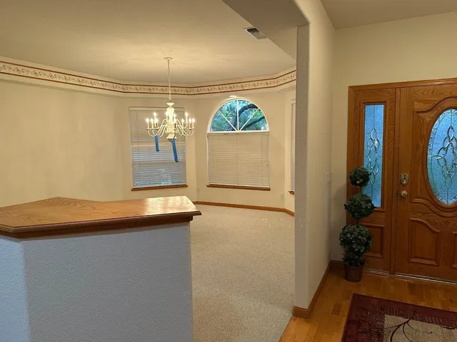 a view of a room with wooden floor