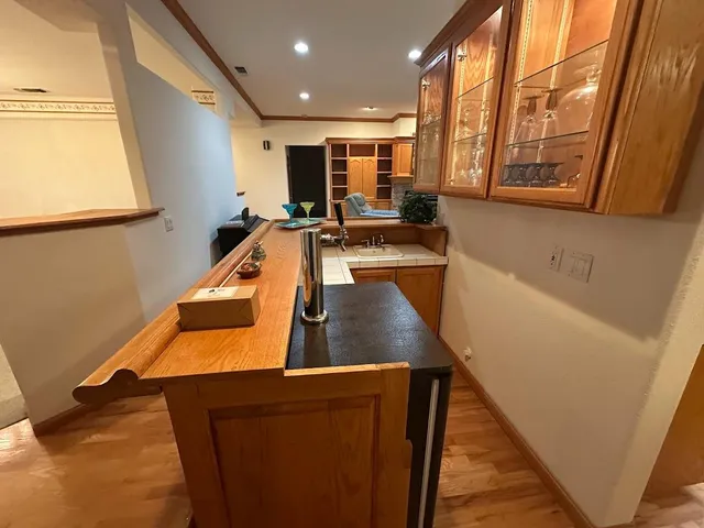 a kitchen with stainless steel appliances granite countertop a table chairs sink and cabinets