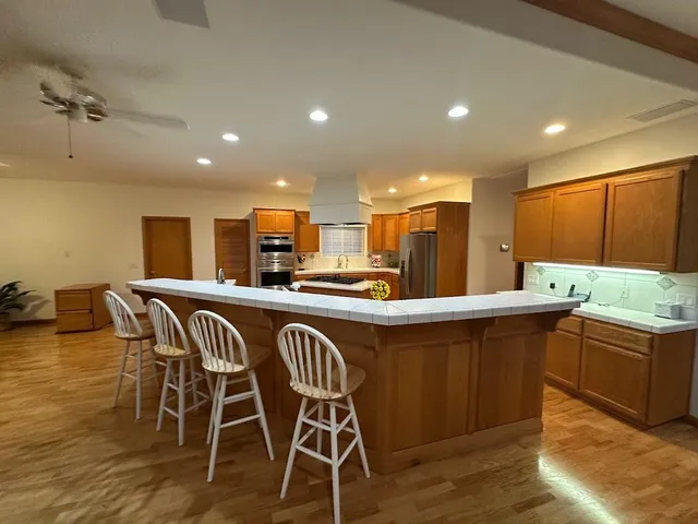 a kitchen with stainless steel appliances a stove a sink and a refrigerator