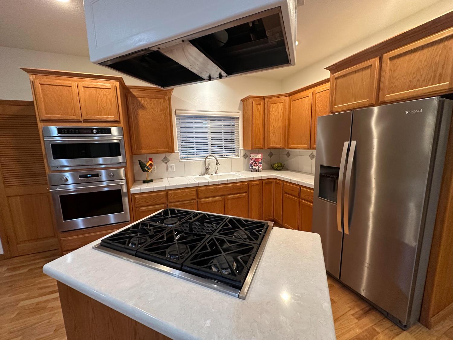 9130 Quail Lake Court Loomis, CA 95650 - Photo 10 of 31 a kitchen with stainless steel appliances a stove a sink and a refrigerator
