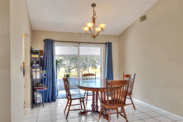 a view of a dining room with furniture and a potted plant