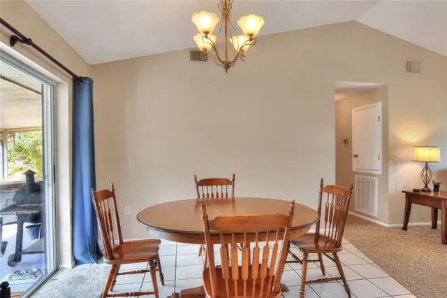 a living room with furniture a chandelier and a chandelier