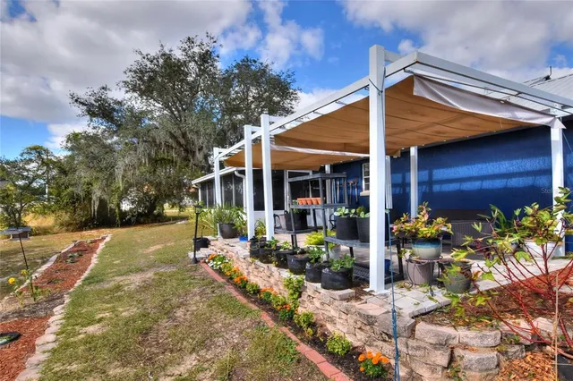 a view of a patio with table and chairs and potted plants
