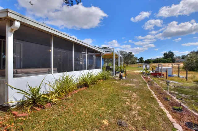 a view of the house with backyard and sitting area