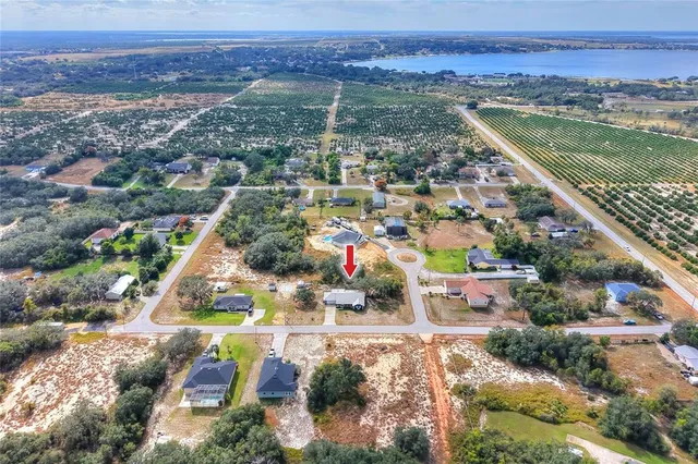 an aerial view of residential building and lake