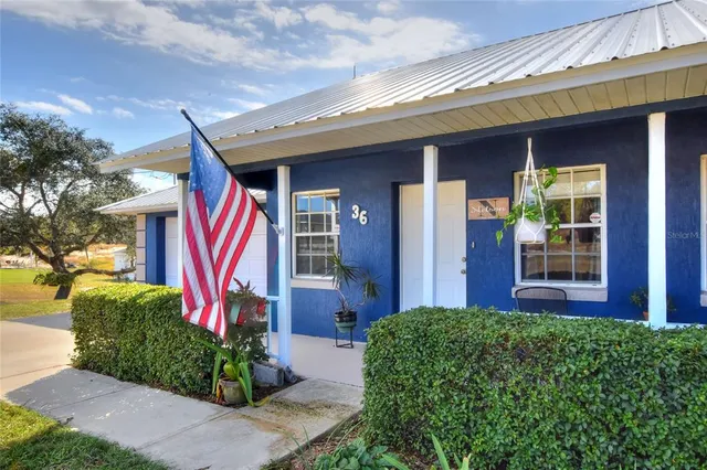 a front view of a house having outdoor seating