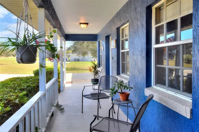 a view of balcony with furniture and garden