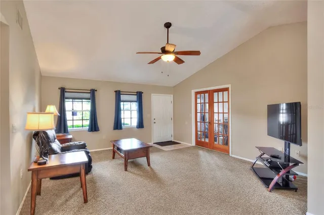 a living room with furniture and a potted plant