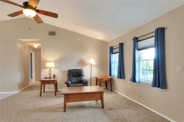 a living room with furniture a air conditioner vent and a window