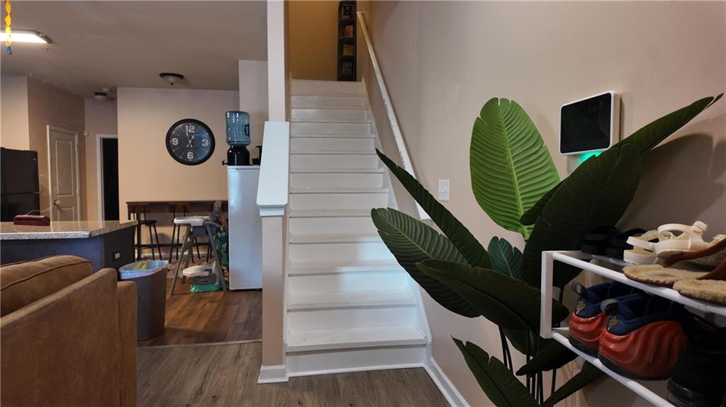 a view of entryway and hall with wooden floor