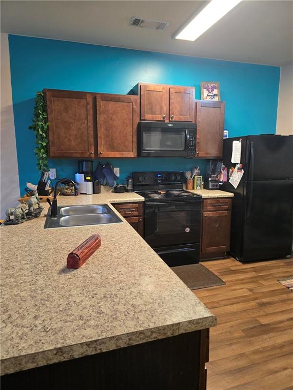 4039 Avalon Road Southwest Atlanta, GA 30331 - Photo 2 of 11 a kitchen with stainless steel appliances granite countertop a sink stove and refrigerator