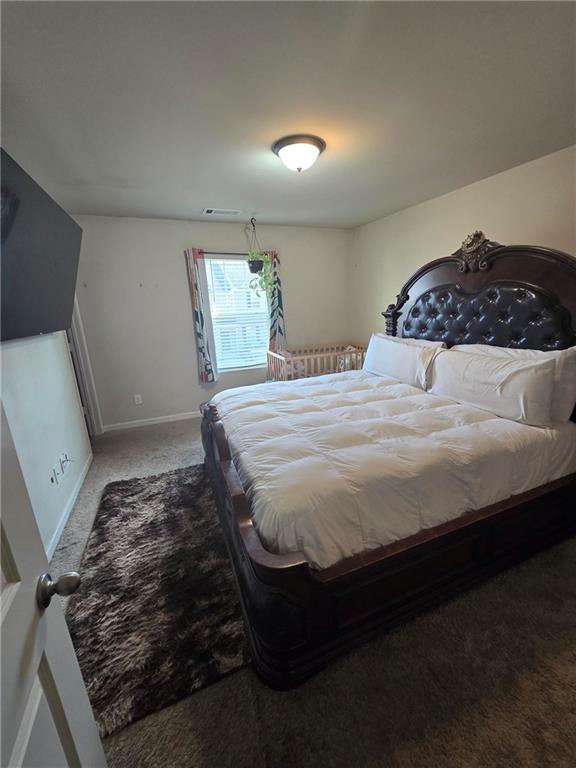 4039 Avalon Road Southwest Atlanta, GA 30331 - Photo 4 of 11 a bedroom with a bed rug and dresser