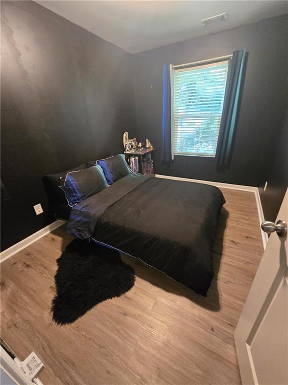 4039 Avalon Road Southwest Atlanta, GA 30331 - Photo 7 of 11 a bed sitting in a bedroom next to a window