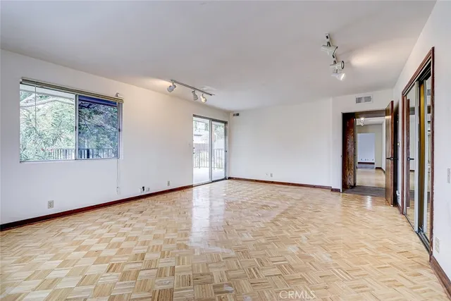 a view of an empty room with windows