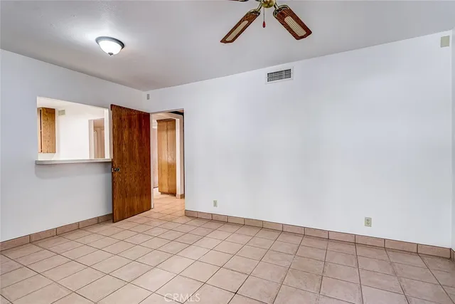a view of hallway with microwave and cabinets