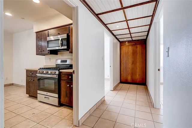 a kitchen with stainless steel appliances a refrigerator and a stove top oven